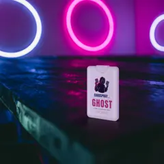 GHOST white bottle on a neon-lit table